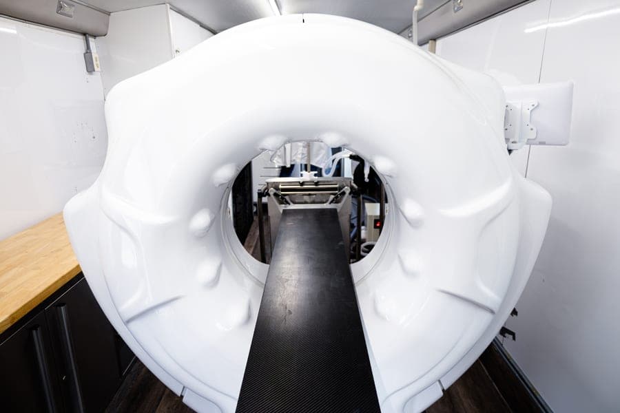 CT scanner with a carbon-fiber table inside the medical bus