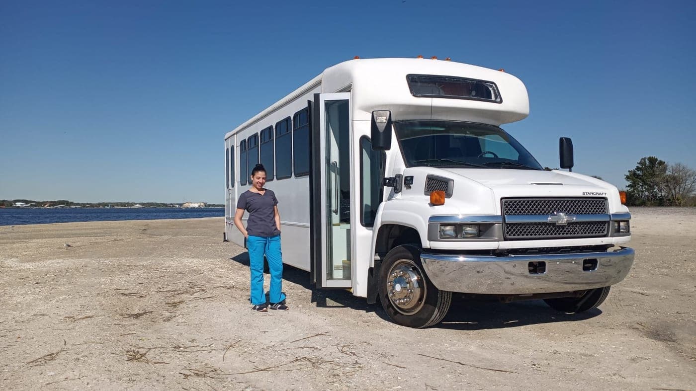 Jax Horizon medical bus at the beach with a team member